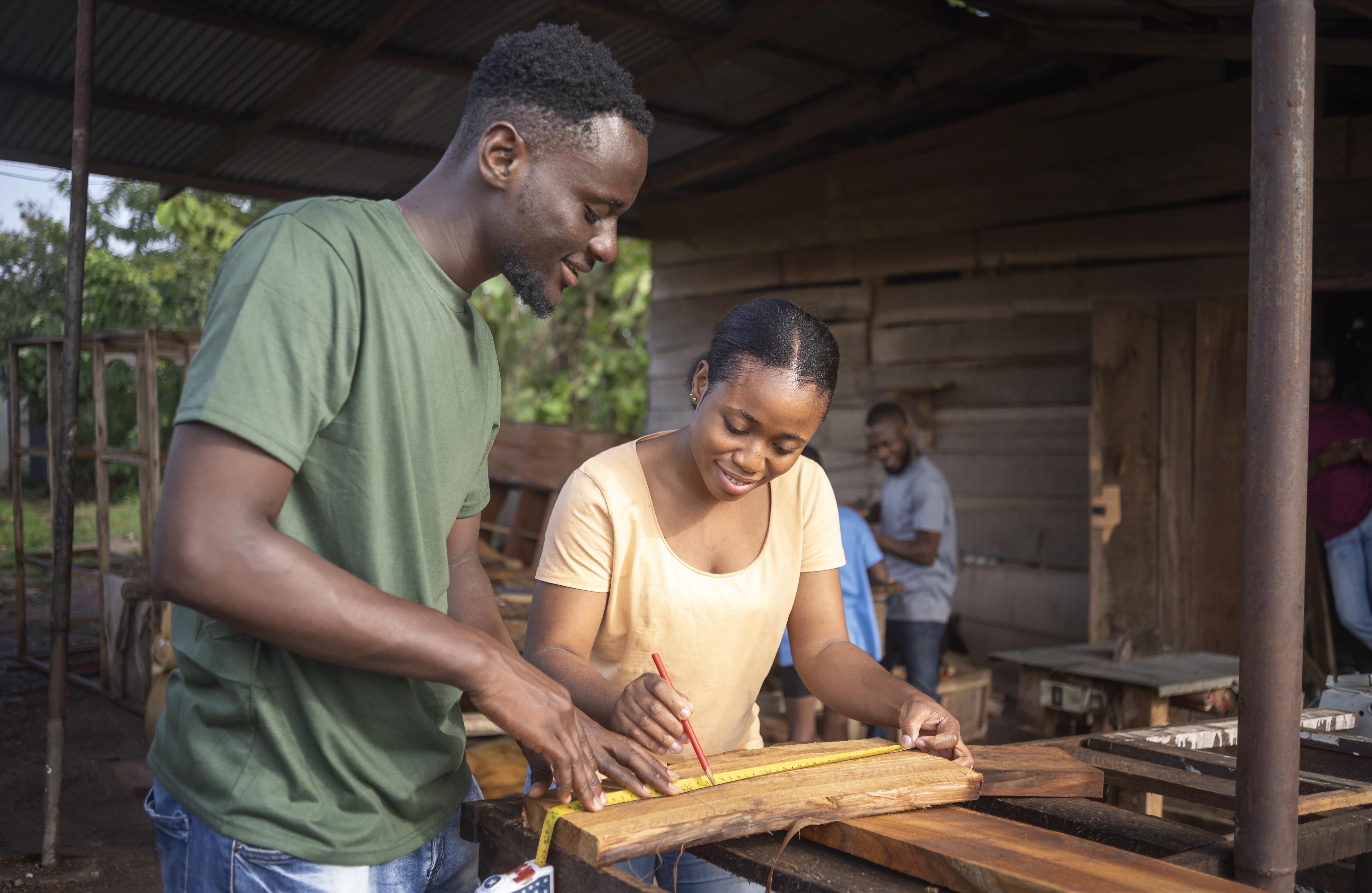 Young people learning practical carpentry skills in a workshop